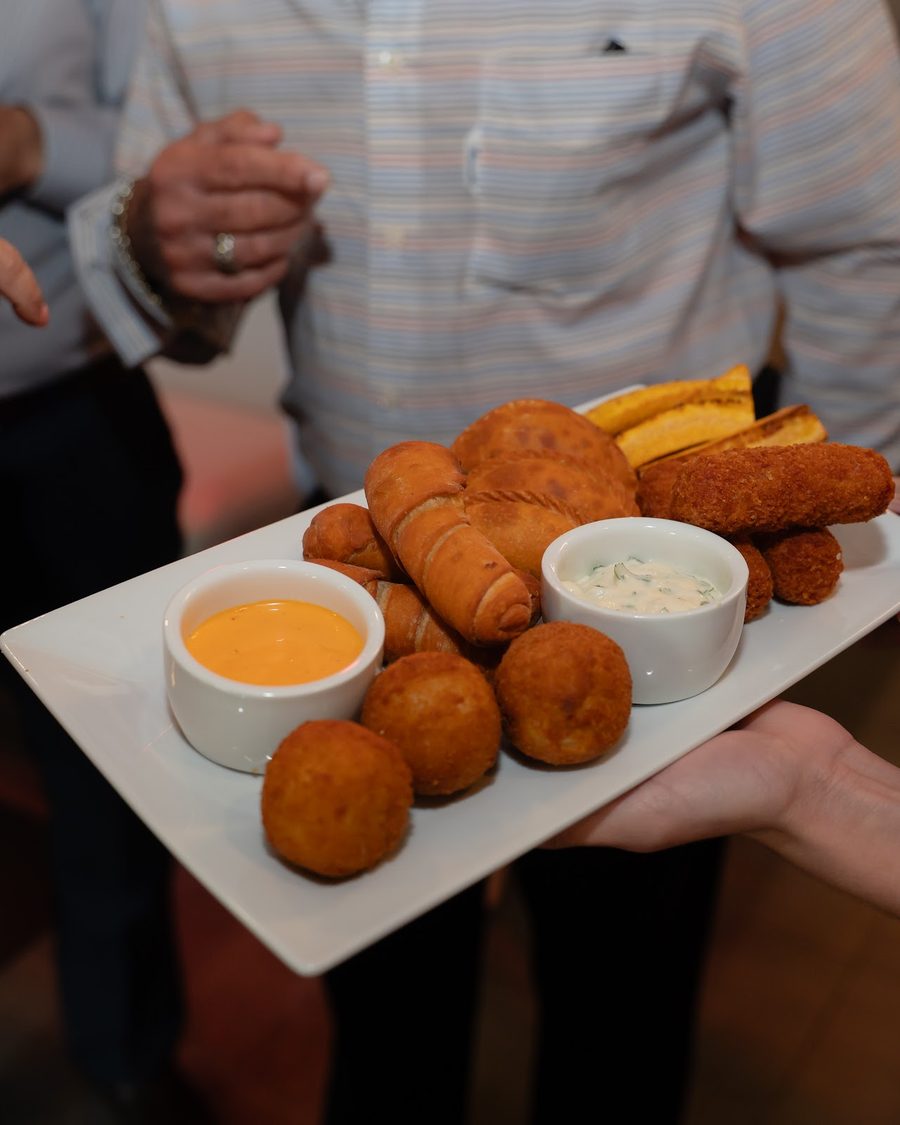 A platter of croquetas, empanaditas and tequeños with two dipping sauces
