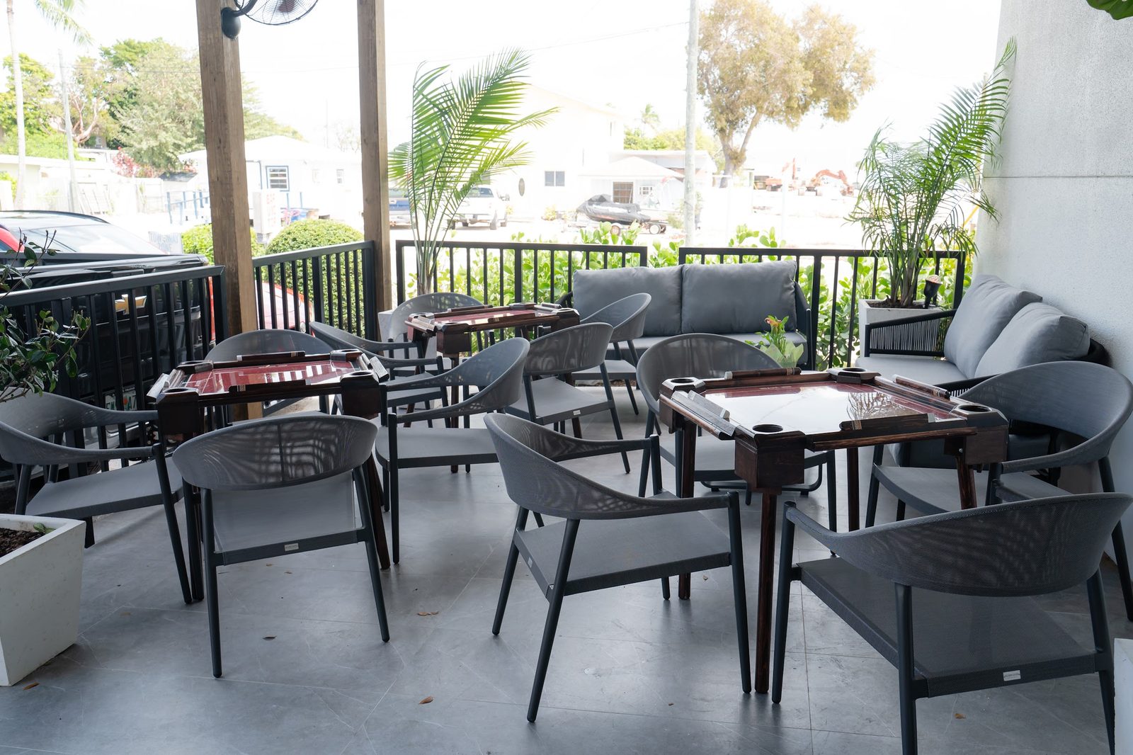The covered patio at Bar Victor with tables, chairs and lounge seating